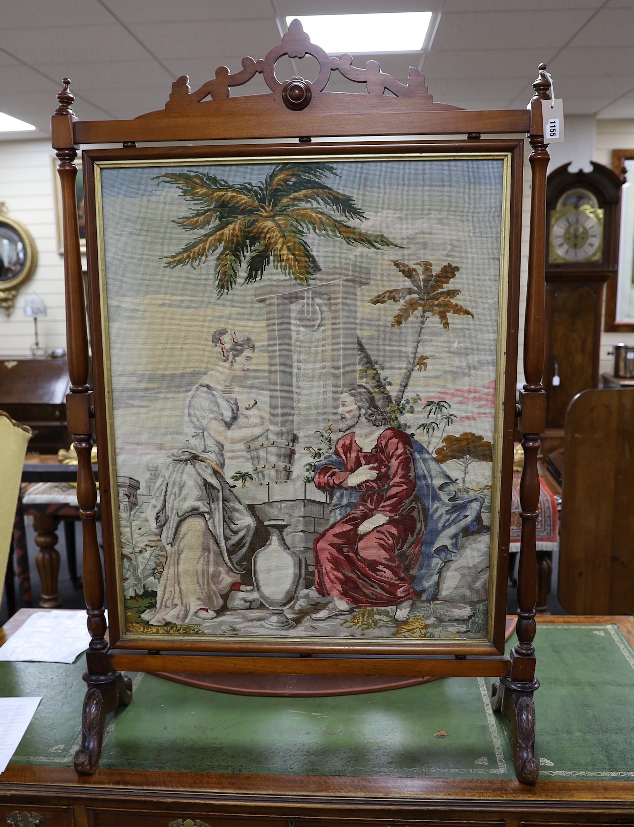 A large Victorian mahogany framed needlepoint firescreen, height 132.5cm high, width 86cm